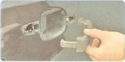5. ...and remove the lock plug from the door panel, overcoming the resistance of the holders.