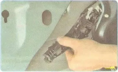 8. Remove the screw securing the rear door outer handle frame.