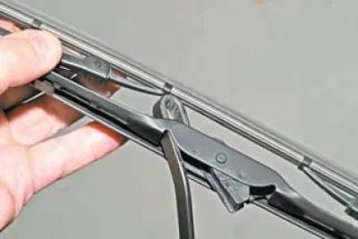 Press and hold the brush lock tab.