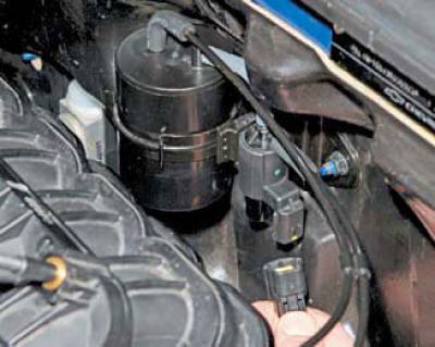 By pressing the locking device of the engine management system wiring harness connector…